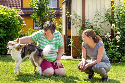 woman with down syndrome with a second woman and a companion dog